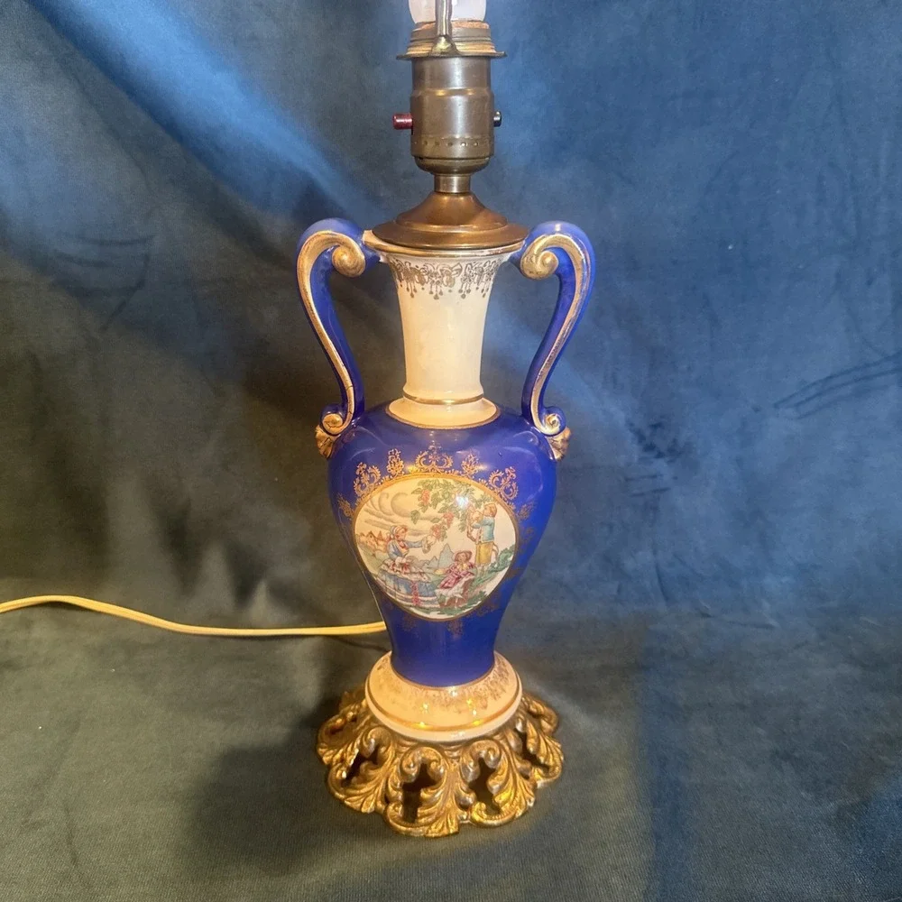 Antique porcelain urn lamp with grape-picking scene.